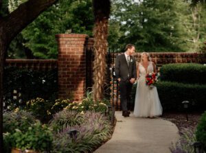 A bride and groom walking down the sidewalk