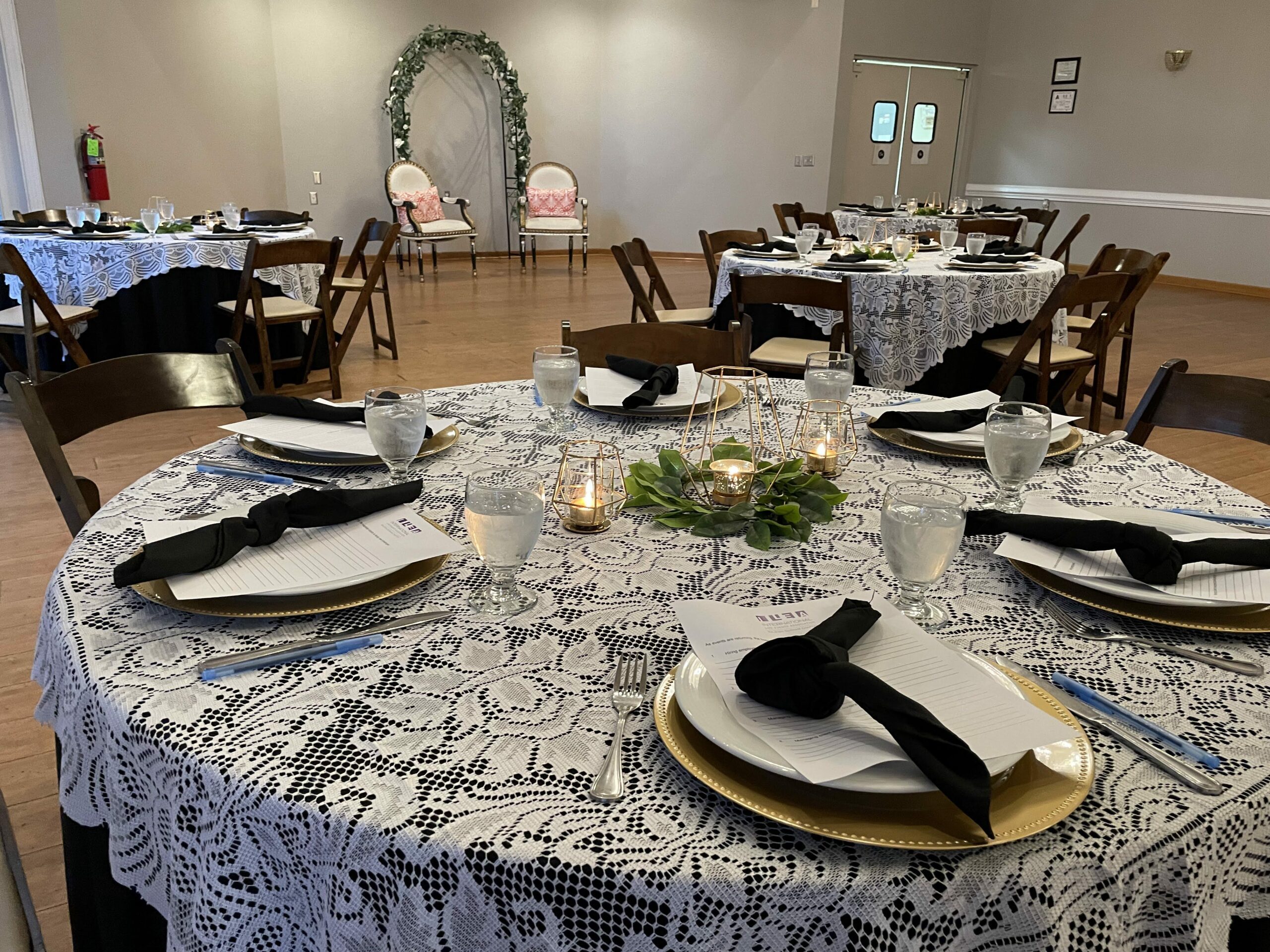 Table setting with pates and menus on round tables